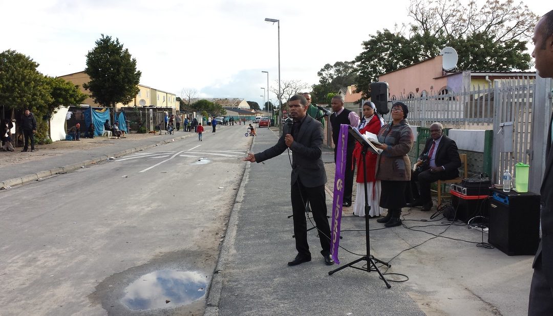 Pastor Quinton preaching the gospel in Cupido street, Bellville South.